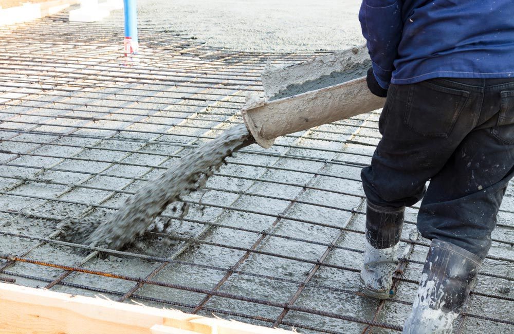 gallery/homeguide-contractor-pouring-ready-mix-concrete-slab-over-rebar-reinforcements